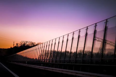 Purple sunset on a reflective surface on the highway Stock Photos