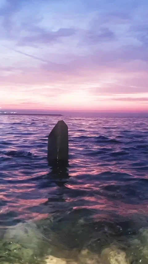 Purple Sunset View with the Ocean Waves water hitting stones on the beach Stock Footage 264963456