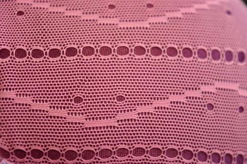 Purple thin fabric mesh is located on purple glossy fabric. Stock Photos