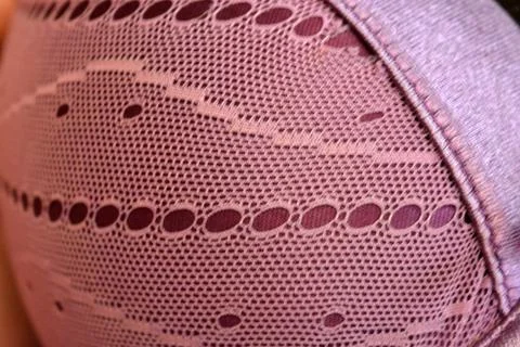 Purple thin fabric mesh is located on purple glossy fabric. Stock Photos