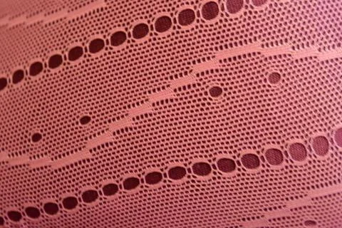 Purple thin fabric mesh is located on purple glossy fabric. 스톡 사진
