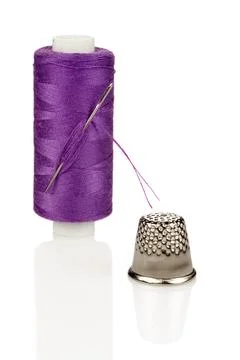 Purple Thread Spool with Needle and Silver Thimble Close-up Isolated Stock Photos