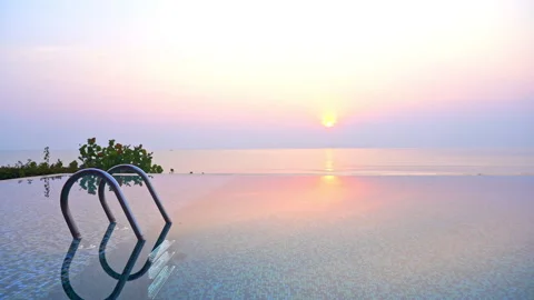Purple Tropical Sunset Above Infinity Pool and Sea, Reflections on Calm Stock Footage 222745645