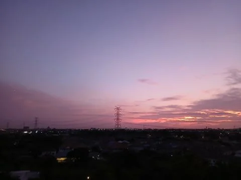 Purple twilight sky background during early morning with electric pylon Stock Photos