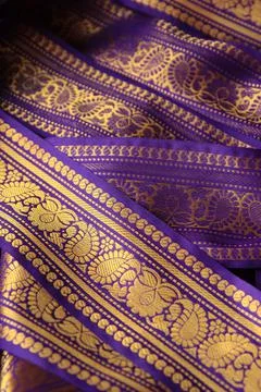 Purple violet Indian Sari border with gold paisley pattern. purple background Stock Photos