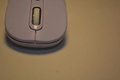 A purple wireless computer mouse isolated on pink background Fotos de archivo