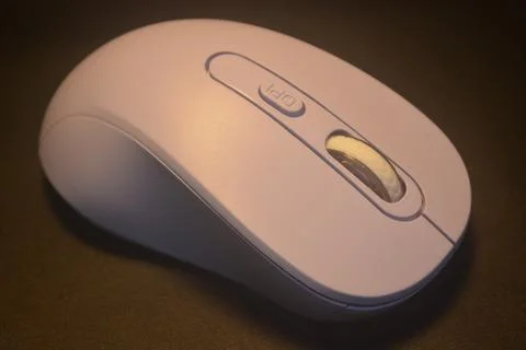 A purple wireless computer mouse isolated on black background Stock Photos