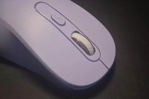 A purple wireless computer mouse isolated on black background Stock Photos