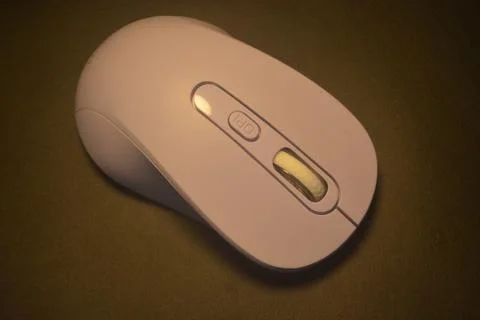 A purple wireless computer mouse isolated on black background Stock Photos