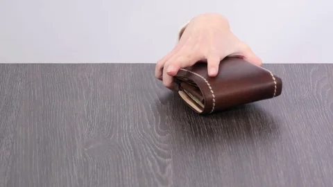 Purse on the table, children's hand stealing wallet. Stock Footage 72850055