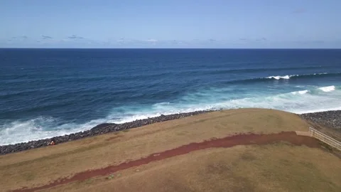 Push 4K video aerial low flight littoral ocean waves bike path in reunion island Stock Footage 175129108