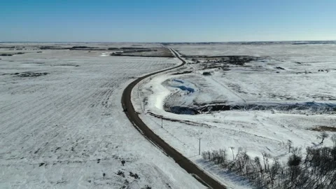 Push in aerial drone shot in small town Saskatchewan rural farmland, following Stock Footage 333715526
