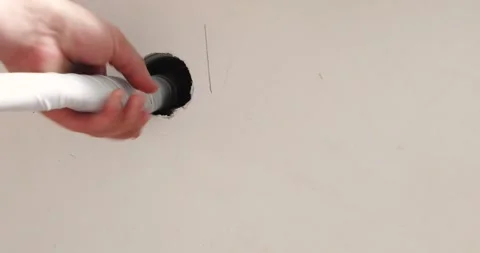 Push the air conditioner pipe through the hole in the wall to the outside. I Stock Footage 337766340