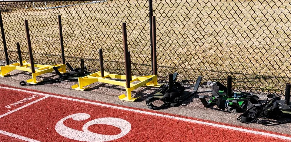 Push and pull weight sleds on the side of a track Stock Photos