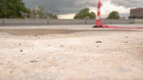 Push broom sweeping through construction site slow motion Stock Footage 131250396