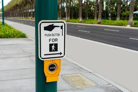 Push Button For Crossing sign on a green post Stock Photos