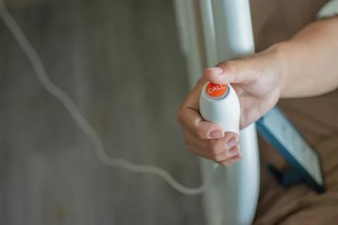 Push button to notify the nurse in the hands of patients at the hospital. Stock Photos