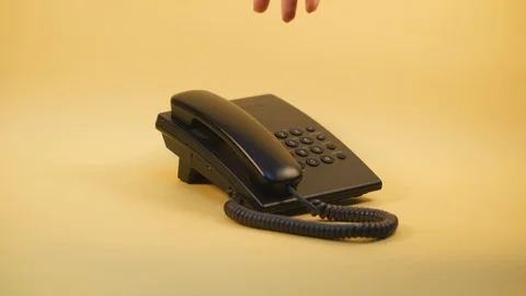Push-button phone on a yellow background Stock Footage 124236907