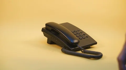 Push-button phone on a yellow background Stock Footage 124237175
