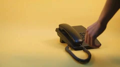 Push-button phone on a yellow background Stock Footage 124237242