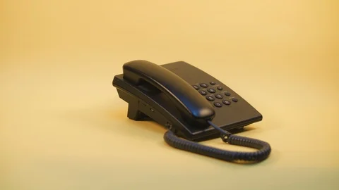 Push-button phone on a yellow background Video stock 124620898