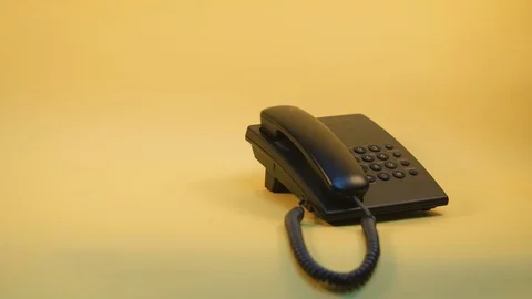 Push-button phone on a yellow background Stock Footage 124621577