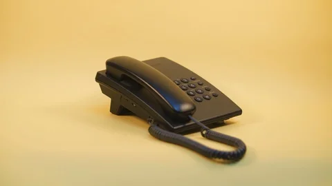 Push-button phone on a yellow background Stock Footage 124621738