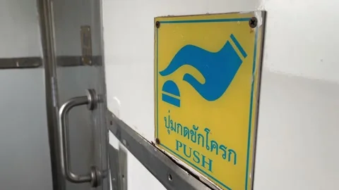 Push button sign on restroom wall on the moving local train, Bangkok, Thailand Stock Footage 225116927