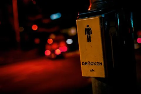 Push-button signal for traffic light control with a man icon and text in germ Stock Photos