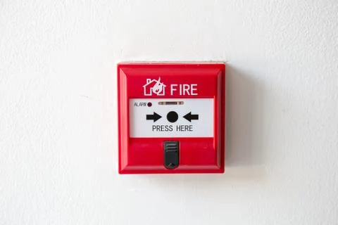 Push button switch fire alarm box on cement wall for warning Stock Photos