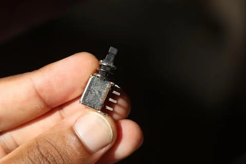 Push button switch held in hand for electronics power control Stock Photos
