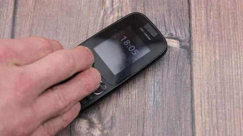 Push-button telephone black old. Outdated mobile phone. Button cell phone. Stock Footage 171167682