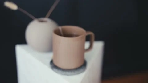 Push in dolly shot of a hot cup of tea on a side table Video stock 165767042