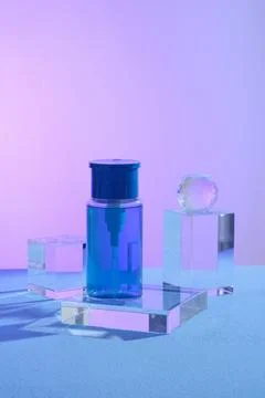 A push down pump dispenser bottle standing on a glass transparent rectangle p 库存照片