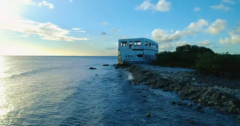 Push in drone shot over small waves to front "shipwreck' on reef barrier Stock-Footage 98036214
