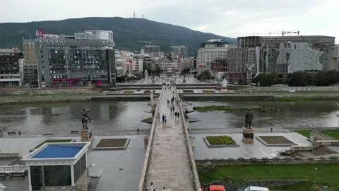 Push in Drone Shot of a People Walking on a Bridge on the River in Skopje Stock Footage 214312757