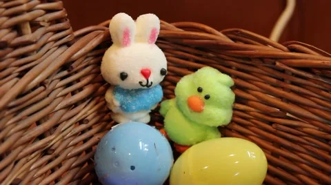 Push In To Easter Eggs and Boy and Girl Bunny Candy In Basket Видео 63010562