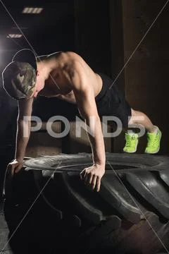 Push up exercise on tire fitness training Stock Photos