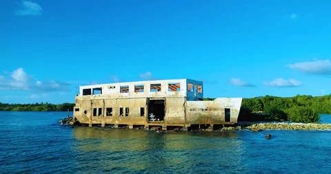 A push in fly over "shipwreck" on reef barrier to reveal island coastline Stock-Footage 98097952