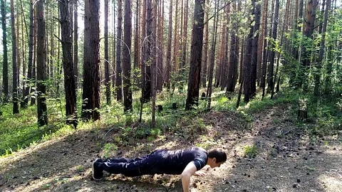 Push-up in the forest from the ground Stock Footage 156187117