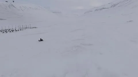 Push Forward Over Snowmobile Departing Dog Sled Base Evoking Arctic Expedition Stock Footage 345329587