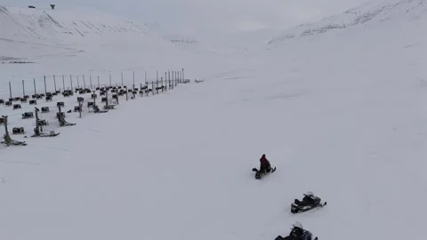 Push Forward Over Snowmobile Rider Departing Dog Sled Base Portraying Arctic Stock Footage 345327422