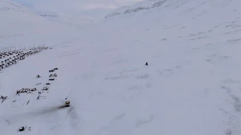 Push Forward Over Snowmobile Speeding Past Dog Kennel Yard Capturing Arctic Stock Footage 345329488