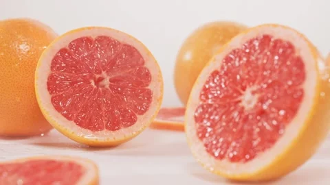 Push the grapefruit forward lay it flat splash water slow motion Video stock 248205174