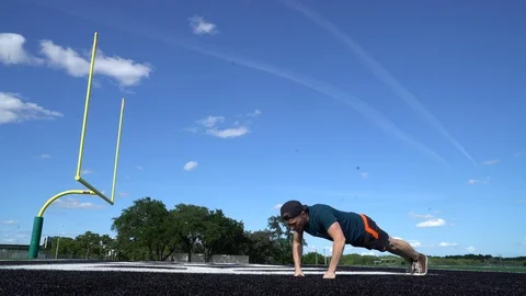 Push up high school athlete in end zone 4k Stock Footage 107447141