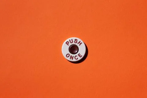"Push once" button on orange background Stock Photos