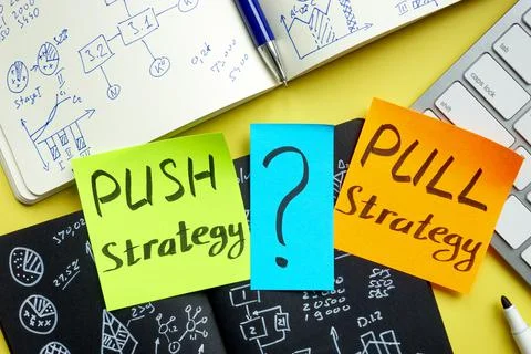 Push or pull strategy in marketing. Notepads and keyboard. Stock Photos