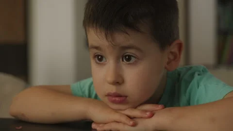 Push out scene of a cute little boy wanting food at the dining table at his home Stock Footage 245752376
