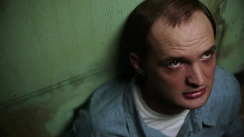 Push-out shot of an inmate looking up in anger, USA, 1960s - Reenactment 스톡 동영상 238866729