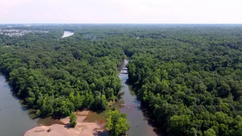 Push over slow moving Catawba River with small road overpass Stock Footage 246087952